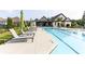 Relaxing community pool with comfortable lounge chairs and umbrellas by the sparkling water at 330 Carriage Glen Ln, Woodstock, GA 30188