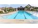 Inviting community pool with lounge chairs, umbrellas, and a nearby building for relaxation at 330 Carriage Glen Ln, Woodstock, GA 30188