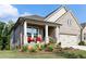 Beautiful home featuring a cozy front porch, manicured lawn, and brick facade at 330 Carriage Glen Ln, Woodstock, GA 30188