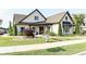 Charming single-story home boasts professionally landscaped lawn, beautiful brick facade, and dark shutters at 330 Carriage Glen Ln, Woodstock, GA 30188