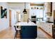 Bright kitchen with a large island, counter seating, modern appliances, and hardwood floors at 330 Carriage Glen Ln, Woodstock, GA 30188
