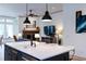 Open concept kitchen with an island with seating and a view to the fireplace living room at 330 Carriage Glen Ln, Woodstock, GA 30188