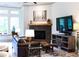 Cozy living room features a stone fireplace, ample light, and comfortable seating at 330 Carriage Glen Ln, Woodstock, GA 30188