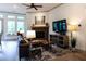 Comfortable living room with fireplace, large windows, and hardwood floors at 330 Carriage Glen Ln, Woodstock, GA 30188