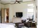 This bedroom has a TV, sitting area, and stylish decor, perfect for relaxation at 330 Carriage Glen Ln, Woodstock, GA 30188