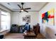 Inviting home office with a ceiling fan, colorful art, and hardwood floors at 330 Carriage Glen Ln, Woodstock, GA 30188