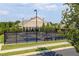 Outdoor pickleball courts with black chainlink fence, benches, and overhead lighting for evening play at 330 Carriage Glen Ln, Woodstock, GA 30188