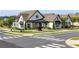 Beautiful street view of a stately brick home with manicured lawn, crosswalk and elegant exterior at 330 Carriage Glen Ln, Woodstock, GA 30188