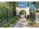 Community walkway with beautiful stonework and landscaping leads to a serene and inviting gate at 330 Carriage Glen Ln, Woodstock, GA 30188
