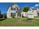 Beautiful two-story home boasts a well-manicured lawn, white brick, and a charming covered entryway at 3332 Grace Farm Ln, Buford, GA 30519