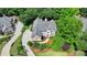 Gorgeous aerial view showcases this home, with a lush private lot and circular driveway at 12130 Helleri Holw, Alpharetta, GA 30005