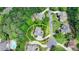 Aerial view of a home with a curved driveway surrounded by lush greenery and neighboring houses at 12130 Helleri Holw, Alpharetta, GA 30005