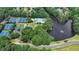An aerial view showcasing tennis courts, a community pool, parking, a clubhouse, and a scenic lake at 12130 Helleri Holw, Alpharetta, GA 30005