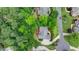 Aerial view of a home with a curved driveway surrounded by lush greenery and a well-maintained lawn at 12130 Helleri Holw, Alpharetta, GA 30005