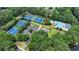 A gorgeous aerial view of a community with tennis courts, a pool, a clubhouse, parking, and beautiful foliage at 12130 Helleri Holw, Alpharetta, GA 30005