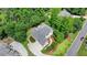 Aerial view of the back of a brick home featuring a spacious backyard with lush landscaping at 12130 Helleri Holw, Alpharetta, GA 30005