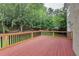 Expansive wooden deck with a view of the serene backyard, surrounded by lush greenery and mature trees at 12130 Helleri Holw, Alpharetta, GA 30005
