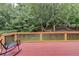 Spacious wood deck overlooking a lush backyard with mature trees and a relaxing hammock at 12130 Helleri Holw, Alpharetta, GA 30005