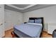 Bedroom features a tray ceiling and hardwood floors at 12130 Helleri Holw, Alpharetta, GA 30005