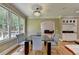 Dining room boasting plenty of natural light, open to the living room with a wet bar at 12130 Helleri Holw, Alpharetta, GA 30005
