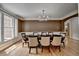 Bright dining room with large window, hardwood floors, modern chandelier, and decorative trim at 12130 Helleri Holw, Alpharetta, GA 30005