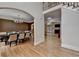 Open concept dining room featuring modern lighting, hardwood floors, and archway to living space at 12130 Helleri Holw, Alpharetta, GA 30005