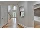 Foyer showcasing high ceilings, hardwood floors, an arched transom window, and staircase at 12130 Helleri Holw, Alpharetta, GA 30005