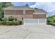 Spacious three-car garage with ample parking space and a well-maintained driveway at 12130 Helleri Holw, Alpharetta, GA 30005