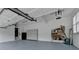 Well-organized garage with storage solutions, ample lighting, and space for vehicles and equipment at 12130 Helleri Holw, Alpharetta, GA 30005