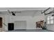 Spacious garage with storage cabinets, shelving, and room for parking and organizing tools at 12130 Helleri Holw, Alpharetta, GA 30005