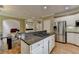 Eat-in kitchen with stainless steel appliances, granite counters, cooktop island, and bar area at 12130 Helleri Holw, Alpharetta, GA 30005