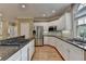 Well-lit kitchen with stainless steel appliances and granite countertops for a modern and stylish cooking space at 12130 Helleri Holw, Alpharetta, GA 30005