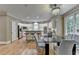 Spacious kitchen and dining area with stainless steel appliances, white cabinets, and a stylish light fixture at 12130 Helleri Holw, Alpharetta, GA 30005