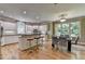 Modern kitchen featuring an island with seating, stainless steel appliances, and a well-lit dining area at 12130 Helleri Holw, Alpharetta, GA 30005