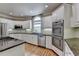 Bright kitchen with stainless appliances, double ovens and granite counters, perfect for cooking and entertaining at 12130 Helleri Holw, Alpharetta, GA 30005