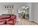 Inviting living room featuring a comfortable red couch and open access to a modern kitchen and dining area at 12130 Helleri Holw, Alpharetta, GA 30005
