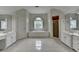 Large main bathroom with dual vanities, a soaking tub, and a glass-enclosed shower at 12130 Helleri Holw, Alpharetta, GA 30005