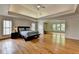 Spacious main bedroom with a hardwood floor, tray ceiling and an additional living space at 12130 Helleri Holw, Alpharetta, GA 30005