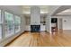 Sitting area featuring hardwood floors, built-in shelves, fireplace, and large windows at 12130 Helleri Holw, Alpharetta, GA 30005