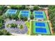 Aerial view of well-maintained tennis courts featuring blue and green playing surfaces and ample parking at 12130 Helleri Holw, Alpharetta, GA 30005