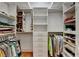 Walk-in closet featuring built-in shelves, drawers, and hanging rods at 12130 Helleri Holw, Alpharetta, GA 30005