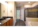 This bathroom has a double sink with granite counters, a walk in shower, and a soaking tub at 1668 Sabastian Ne Pt, Atlanta, GA 30329