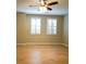 This bedroom features shutters on the windows, a ceiling fan, and wood floors at 1668 Sabastian Ne Pt, Atlanta, GA 30329
