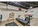 Bright basement living area with sofa, playful decor, and open painted ceiling at 394 Thornbrooke Dr, Hiram, GA 30141