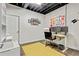 Basement office space with modern desk and chair, with yellow accent rug at 394 Thornbrooke Dr, Hiram, GA 30141