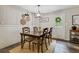 Charming dining room featuring natural light, a farmhouse dining table, and wainscoting accents at 394 Thornbrooke Dr, Hiram, GA 30141