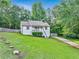 Charming home with a well-manicured lawn and inviting staircase leading to a cozy front porch at 394 Thornbrooke Dr, Hiram, GA 30141