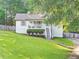 Lovely home featuring a well-kept lawn, white siding, and a charming front porch with staircase access at 394 Thornbrooke Dr, Hiram, GA 30141