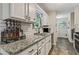Well-lit kitchen featuring granite countertops, modern appliances, and ample storage space at 394 Thornbrooke Dr, Hiram, GA 30141