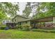 Back exterior view of a home with a covered patio, deck, and large yard at 480 Pineburr Ln, Stone Mountain, GA 30087